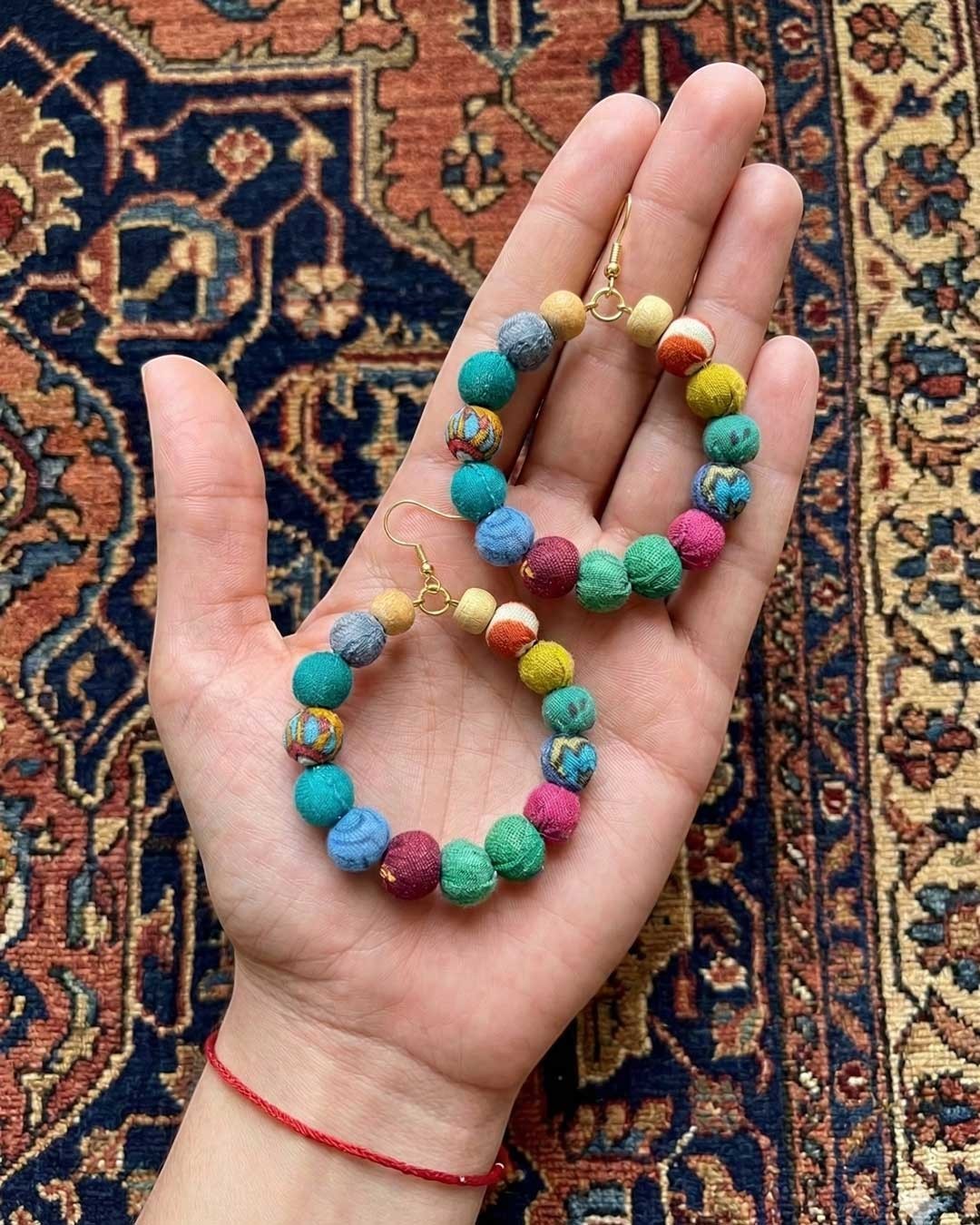 Cultural Elements multicolor fabric-wrapped beaded hoop earrings with gold hooks, handmade from recycled textiles.