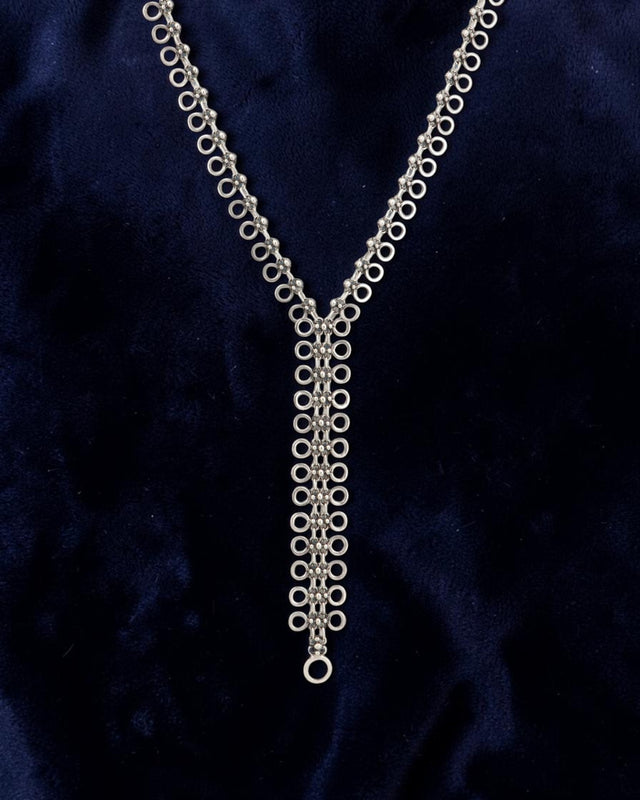 Cultural Elements silver-tone metal alloy lariat necklace with cutout discs and Y-shaped silhouette.