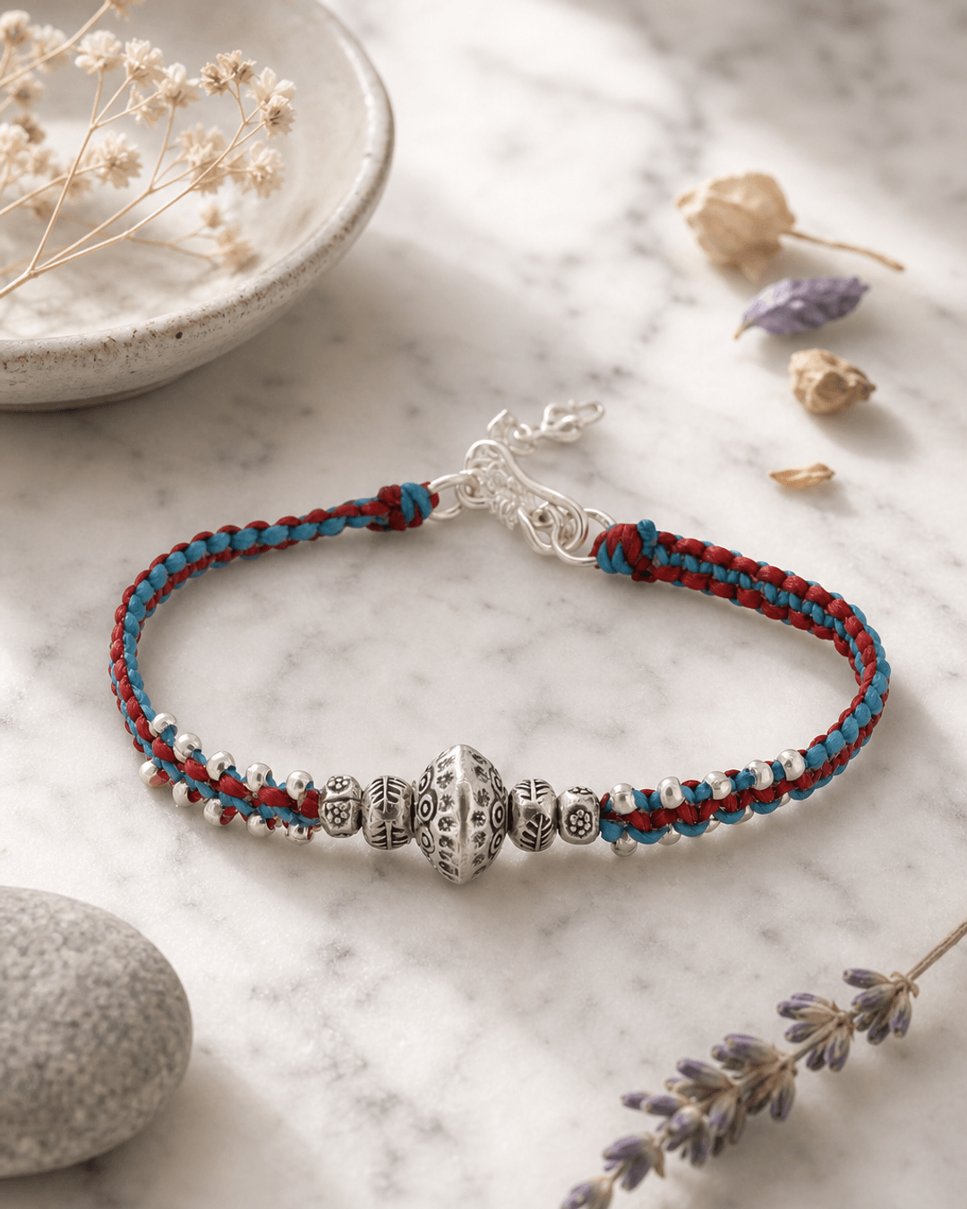 Duotone Sterling Silver Etched Bead Braided Bracelet — bracelets, editorial marble lifestyle photo
