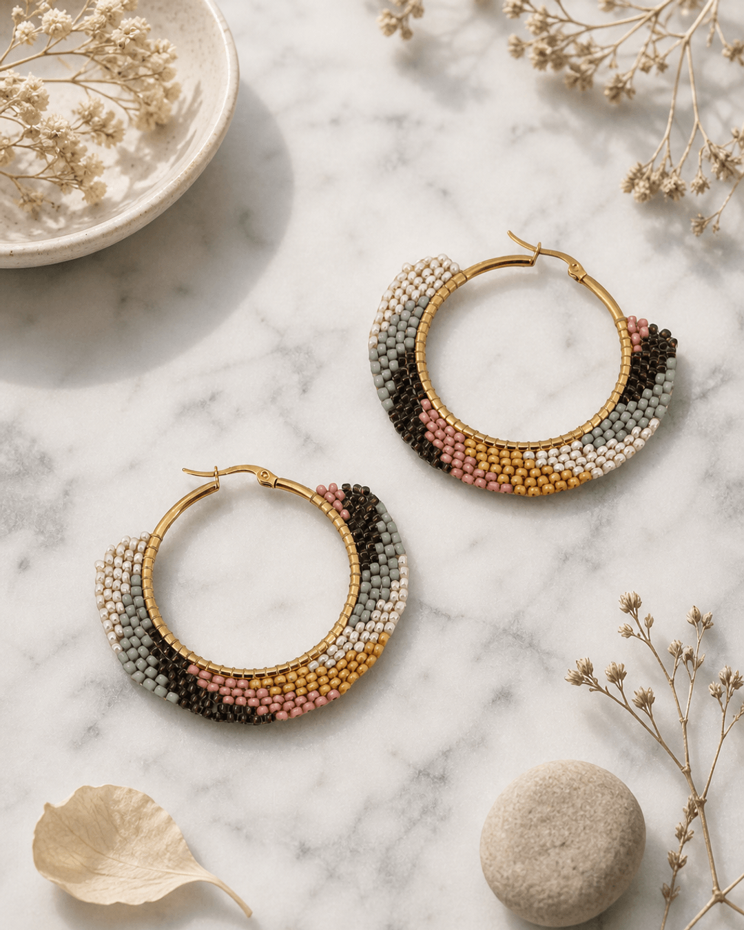 Earth-Tone Beaded Hoop Earrings — earrings, editorial marble lifestyle photo