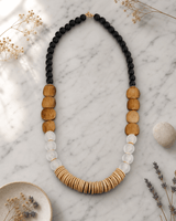 Earthform Statement Necklace – Coconut Wood, Bone & Recycled Glass — necklaces, editorial marble lifestyle photo