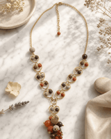 Earthtone heart link necklace with warm brown and terracotta tones displayed on white marble surface