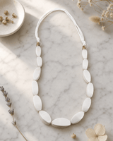 Lightweight Statement Necklace in Soft White — necklaces, editorial marble lifestyle photo
