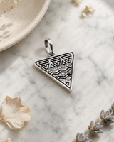 Etched Tribal Triangle Pendant — charms & pendants, editorial marble lifestyle photo