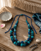 Fair Trade Acai Beads and Iraca Hand-woven Sea Tones Necklace, Colombia — necklaces, editorial wood lifestyle photo