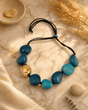 Fairtrade Handcrafted Tagua-Pods Teal Gold Statement Colombia — necklaces, editorial marble warm lifestyle photo