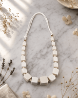 Geometric Cube Wood Necklace — necklaces, editorial marble lifestyle photo