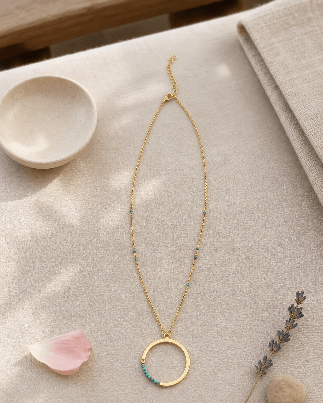 Gold-Plated Brass Circle Pendant Necklace with Turquoise Bead Accents — necklaces, meditation corner lifestyle photo
