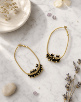 Gold-Plated Brass Hoop Earrings with Black Glass Beads — earrings, editorial marble lifestyle photo