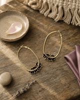 Gold-Plated Brass Hoop Earrings with Black Glass Beads — earrings, editorial wood lifestyle photo