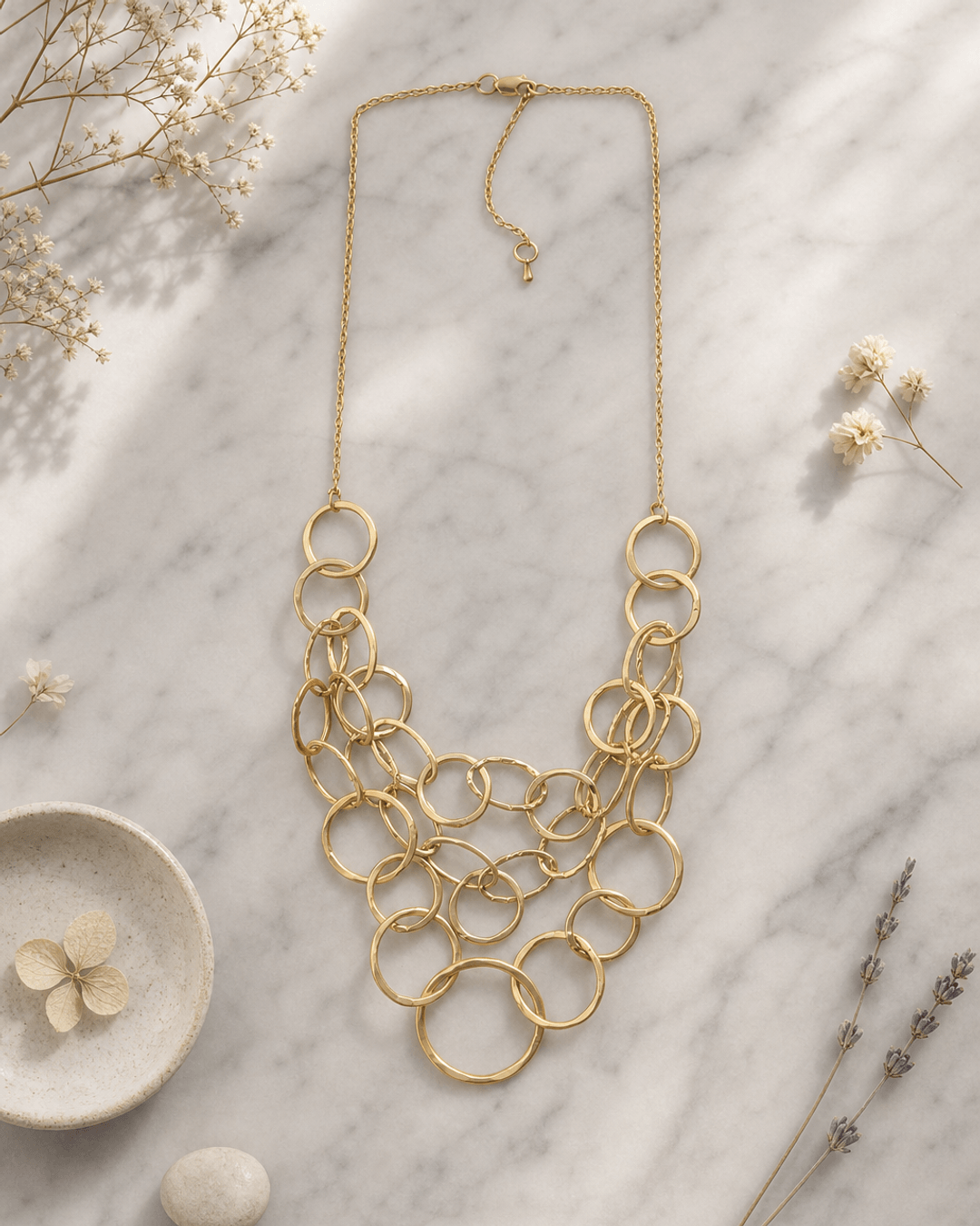 Gold-Tone Multi-Layered Hammered Ring Necklace — necklaces, editorial marble lifestyle photo