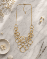 Gold-Tone Multi-Layered Hammered Ring Necklace — necklaces, editorial marble lifestyle photo