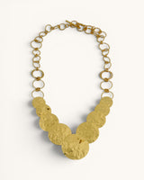 Hammered brass cascading disc necklace full front view on white background, toggle clasp and open link chain visible