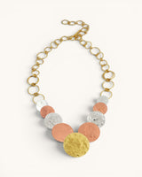 Hammered tri-tone disc necklace full overhead view on white background showing complete chain with extender clasp and all disc pendants