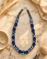 Hand-Painted Floral Ceramic Bead Necklace with Crochet Accents — necklaces, editorial marble warm lifestyle photo