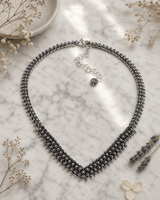 Hill Tribe Silver Floral V-Necklace — necklaces, editorial marble lifestyle photo