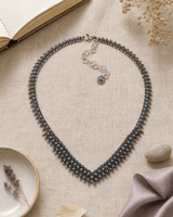 Hill Tribe Silver Floral V-Necklace — necklaces, flatlay linen lifestyle photo