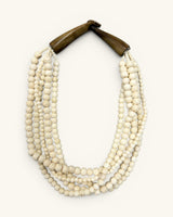 Indian bone bead 5-strand layered necklace with dark horn closure, flat lay front view on white background