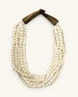 Indian bone bead 5-strand layered necklace with dark horn closure, flat lay front view on white background