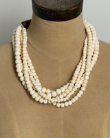Indian bone bead 5-strand layered necklace draped on a tan dress form, front view showing bead arrangement and drape