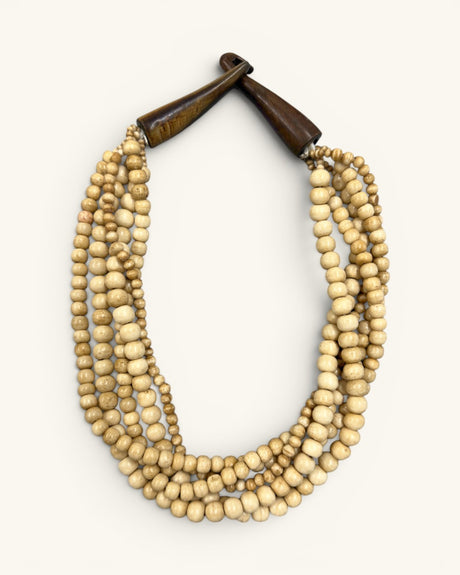 Five-strand Indian bone bead necklace laid flat on white background, horn hook closure fastened at top, front view