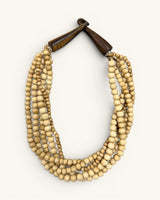Five-strand Indian bone bead necklace on white background, horn hook closure fastened, viewed from a slight left angle