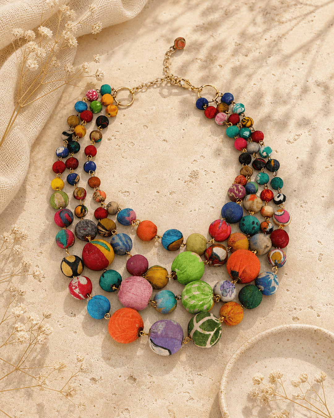 Kantha Multi-Strand Textile Wrapped Statement Necklace — necklaces, editorial travertine lifestyle photo