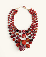 Four-strand kantha sari-wrapped fabric bead statement necklace in red tones, full front view on white background