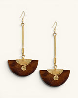 Kenyan handmade brass and wood half-moon drop earring pair displayed at staggered heights on white background, showing wood grain