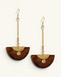 Kenyan handmade brass and wood half-moon drop earring pair displayed at staggered heights on white background, showing wood grain