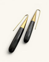 Kanai Kenyan horn and brass threader earrings at a diagonal angle highlighting polished horn texture and brass cone cap detail