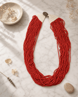Large Red Bead Strands Statement Necklace — necklaces, editorial marble lifestyle photo