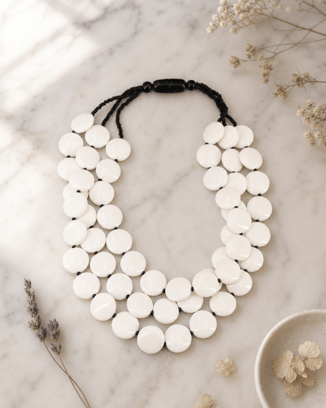 Modern Tibetan White Resin Disc Necklace — necklaces, editorial marble lifestyle photo