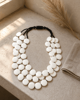 Modern Tibetan White Resin Disc Necklace — necklaces, outdoor sunlit window ledge lifestyle photo