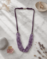 Multi-Strand Amethyst Beaded Necklace with Braided Cord — necklaces, editorial marble lifestyle photo