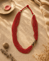 Multi-Strand Red Glass Bead Necklace with Hand-Painted Ceramic Accents — necklaces, vibey closeup lifestyle photo