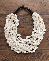 Cultural Elements soft white wood disc necklace with twisted strands and horn closure.