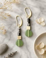 Olivine & Black Stone Drop Earrings with Gold Accents — earrings, editorial marble lifestyle photo
