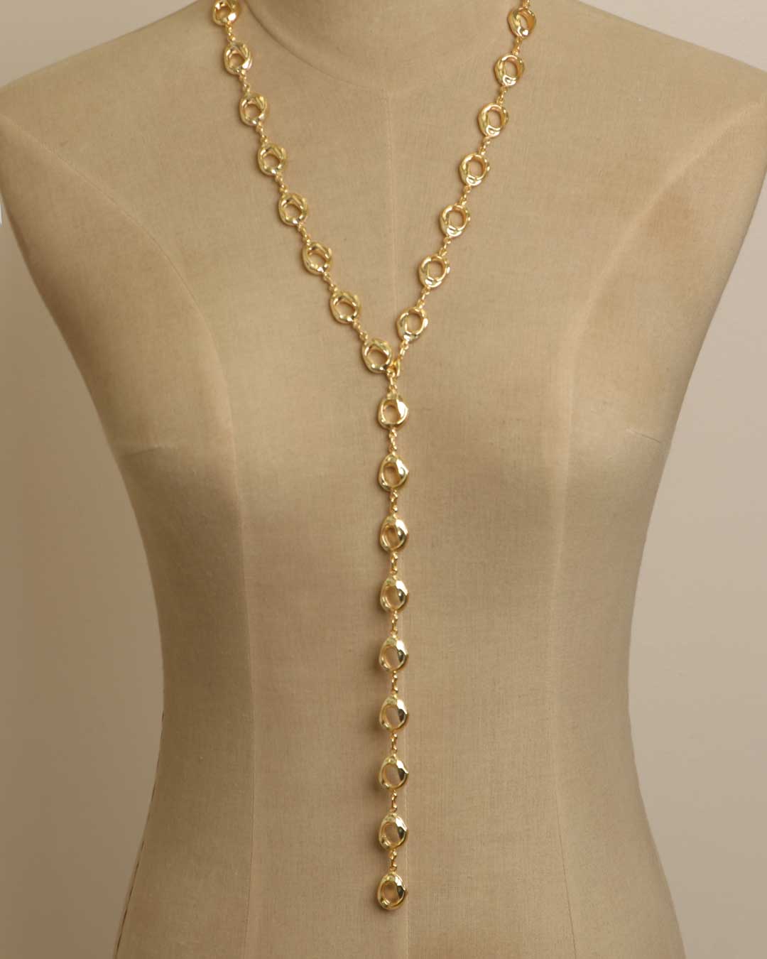Sculpted Open Links Multi Style Necklace in gold styled as lariat Y-drop on dress form, showing full open-ring chain and long center drop