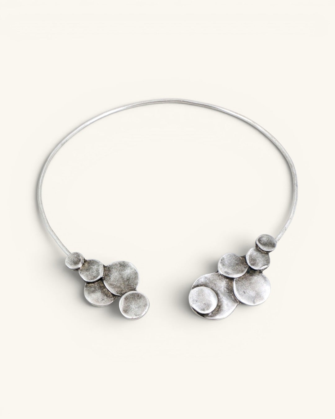 Silver-plated pewter collar necklace shown open on white background, stacked disc clusters visible at both wire ends