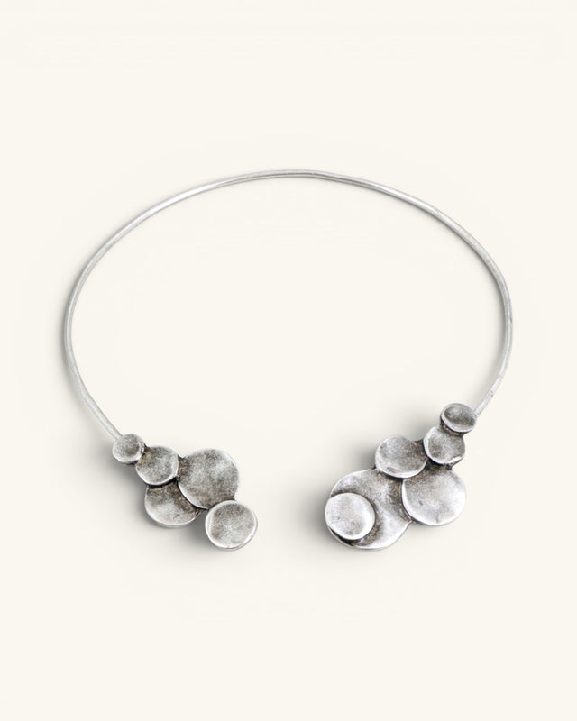 Silver-plated pewter collar necklace shown open on white background, stacked disc clusters visible at both wire ends