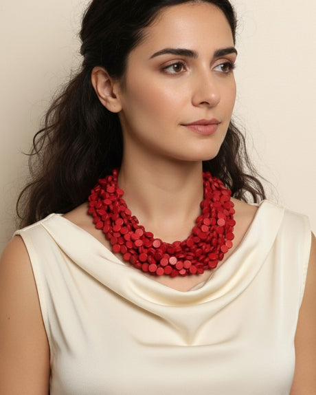 Cultural Elements twisted multi-strand red wooden disc necklace with horn closure.