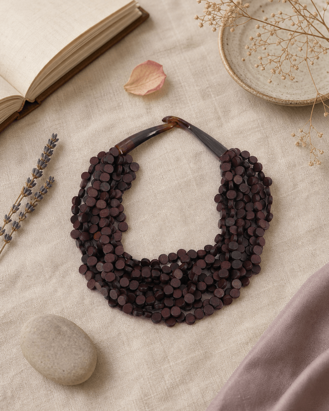 Rich Brown Twist Wood Necklace — necklaces, flatlay linen lifestyle photo