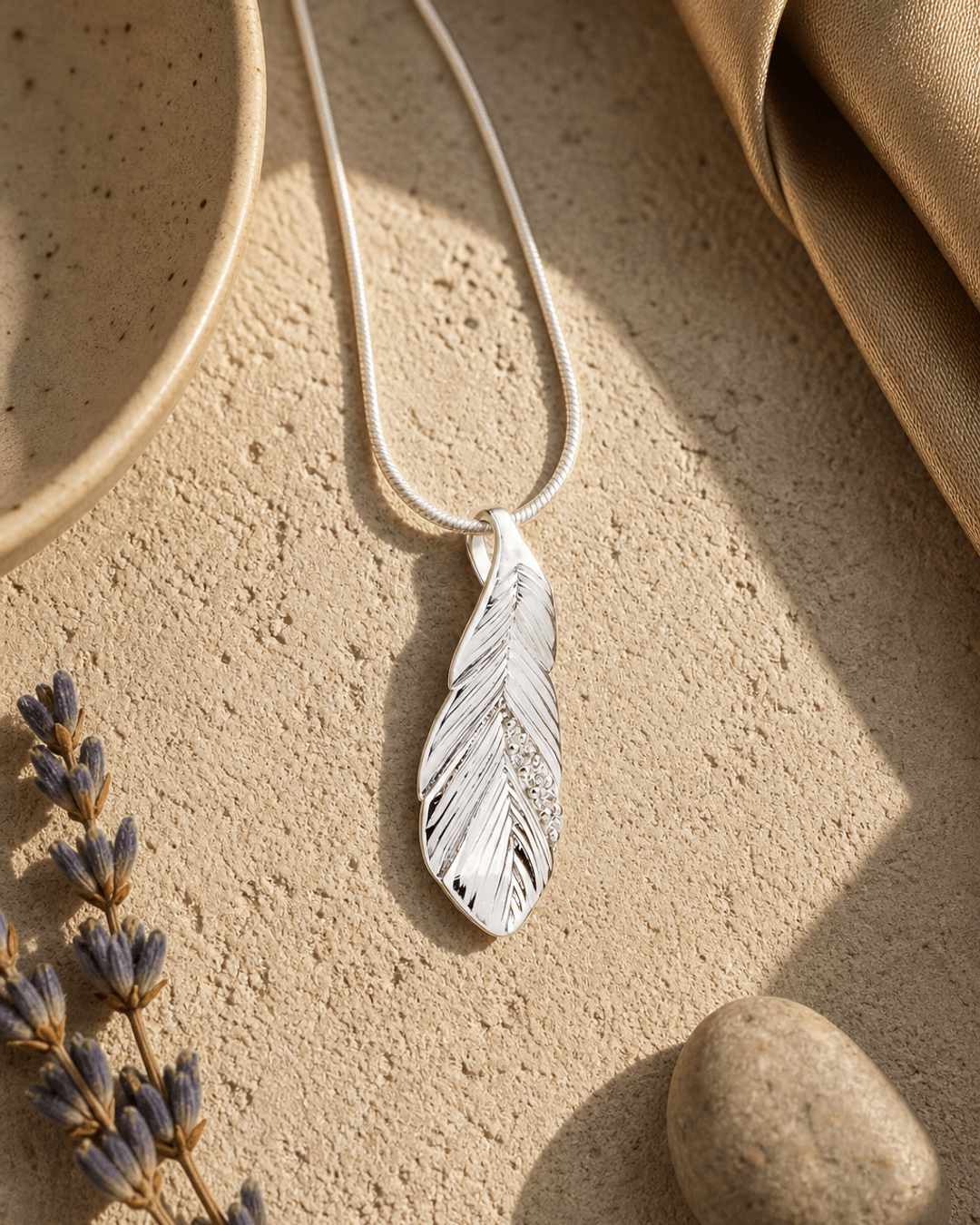 Silver and Crystal Textured Feather Pendant — charms & pendants, vibey shadow lifestyle photo