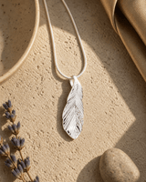 Silver and Crystal Textured Feather Pendant — charms & pendants, vibey shadow lifestyle photo