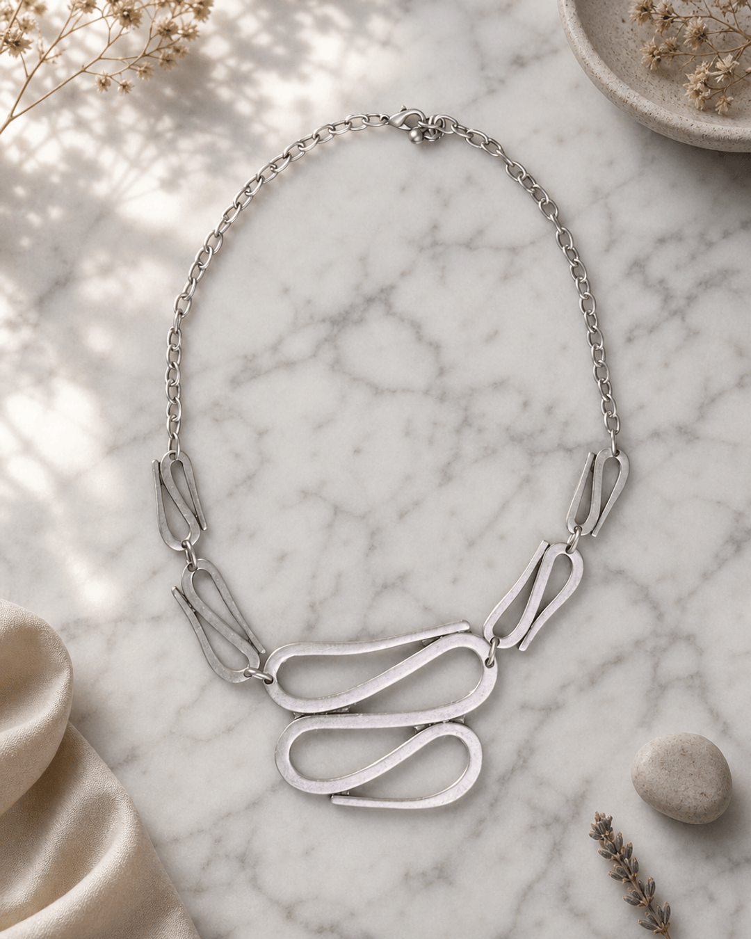 Swirly S-Shaped Statement Necklace — necklaces, editorial marble lifestyle photo