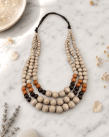 Tri-Color Layered Wood Bead Necklace — necklaces, editorial marble lifestyle photo