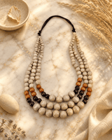 Tri-Color Layered Wood Bead Necklace — necklaces, editorial marble warm lifestyle photo