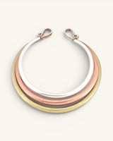 Tri-Tone Brass Collar Necklace front view on white background, three concentric silver, copper, and brass rings with hook clasps at top
