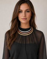 Tri-Tone Brass Collar Necklace worn by a model over a black sheer blouse, silver, copper, and brass bands sitting at the throat